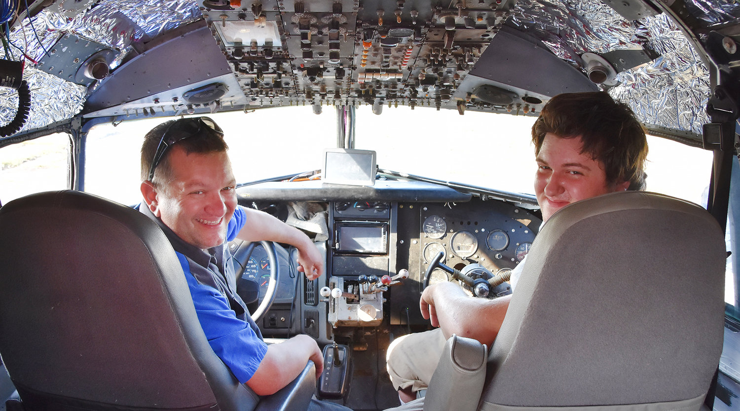Gino Lucci of Nashville, Mich., and his son Giacinto (right) sit in the cockpit of the ‘Fabulous Flamingo.’